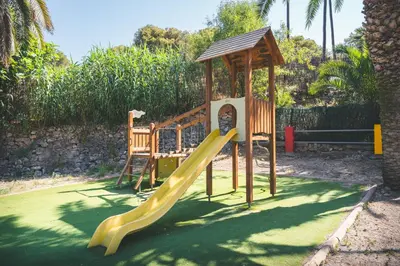a playground with a slide and a gazebo at HolaCamp Sitges Relax in Sitges