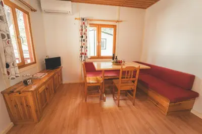 a living room with a couch and a table and chairs at HolaCamp Sitges Relax in Sitges