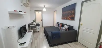 a living room with a couch and a desk at APARTAMENTS B O D CoLLBLANC in Hospitalet de Llobregat