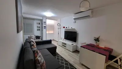 a living room with a couch and a tv at APARTAMENTS B O D CoLLBLANC in Hospitalet de Llobregat