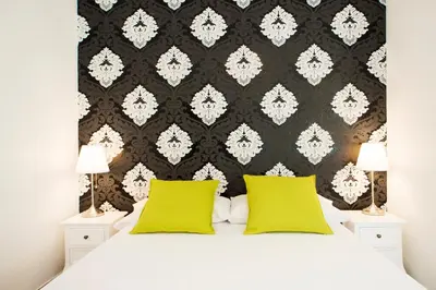 a bedroom with a bed with two yellow pillows at Fira Guest House in Barcelona
