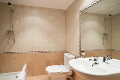 a bathroom with a toilet and a sink and a mirror at Fira Guest House in Barcelona