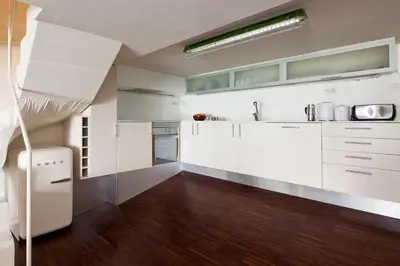 a kitchen with white cabinets and wood floors at Apartment Barcelona Rentals - Private Pool and Garden Center in Barcelona