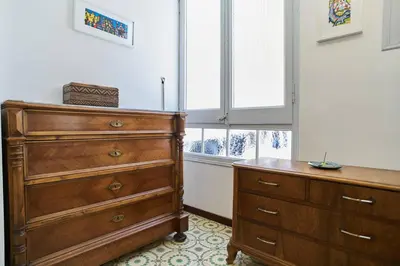 a bedroom with a dresser and a window at My Home in Barcelona in Barcelona