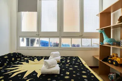 a bedroom with a bed with towels on it at My Home in Barcelona in Barcelona