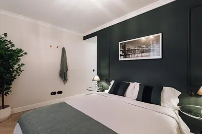 a bedroom with a bed and a black wall at Lunalux Apartment in Barcelona