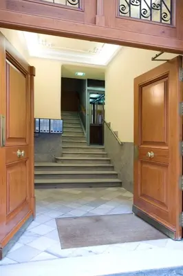 an empty hallway with stairs and wooden doors at Lunalux Apartment in Barcelona