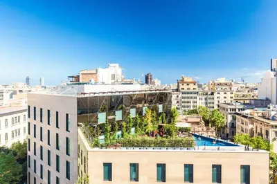 a building with a garden on the top of it at Eurostars Barcelona Central in Barcelona
