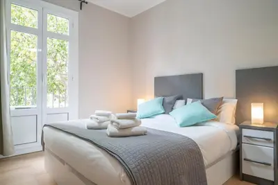 a bedroom with a large bed with towels on it at The Family Host - Lost Garden Ciutadella Park in Barcelona