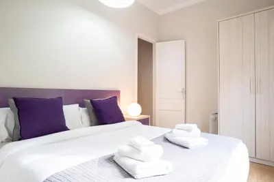 a bedroom with a large white bed with towels on it at The Family Host - Lost Garden Ciutadella Park in Barcelona