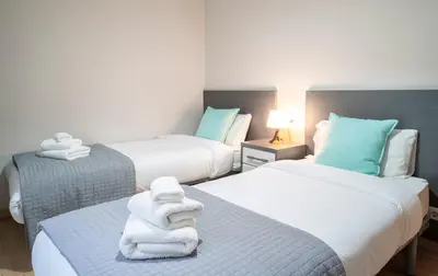 two beds in a room with towels on them at The Family Host - Lost Garden Ciutadella Park in Barcelona
