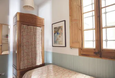 a bedroom with a bed and a window at ApartEasy - Authentic Family Apartment in Barcelona