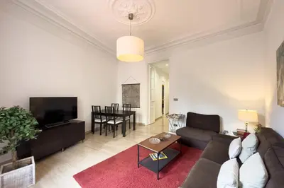 a living room with a couch and a table at ApartEasy - Passeig de Gracia in Barcelona