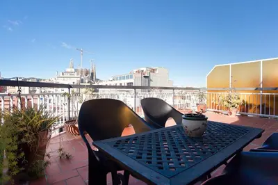 a table and chairs sitting on a balcony at ApartEasy - Atic Sagrada Familia in Barcelona