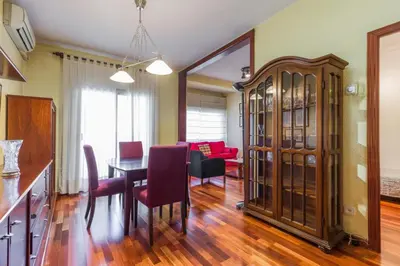 a dining room and living room with a table and chairs at ApartEasy - Port Barcelona in Barcelona
