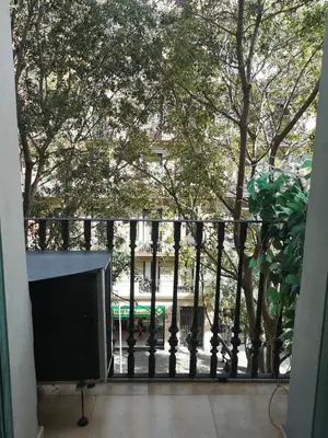 a balcony with a black fence and trees at ApartEasy - Family Sant Antoni apt. in Barcelona