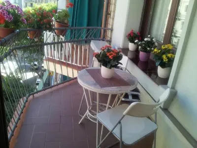 a table and chairs on a balcony with potted plants at ApartEasy - Family Apartment Sant Antoni in Barcelona