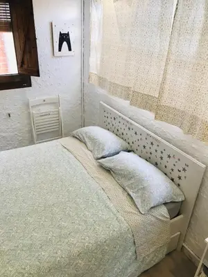 a bedroom with a bed with two pillows and a window at Heart of Gracia in Barcelona