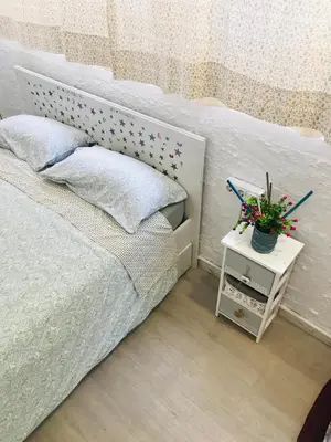 a bedroom with a bed and a table with flowers at Heart of Gracia in Barcelona