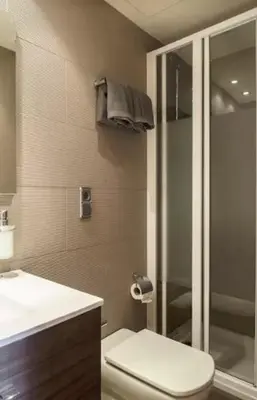 a bathroom with a shower and a toilet and a sink at Tendency Plaza España in Barcelona