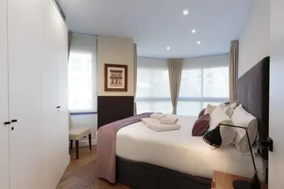 a bedroom with a large bed and a window at RAMBLA POBLENOU Luxury in Barcelona