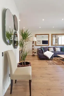 a living room with a couch and a chair at RAMBLA POBLENOU Luxury in Barcelona