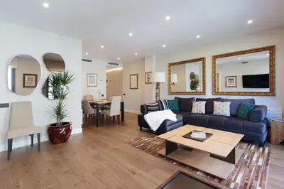 a living room with a blue couch and a table at RAMBLA POBLENOU Luxury in Barcelona