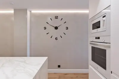 a clock on a white wall in a kitchen at RAMBLA POBLENOU Luxury in Barcelona