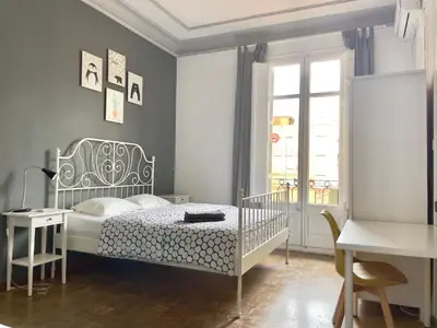 a bedroom with a bed and a desk at Grand Central Apartment in Barcelona