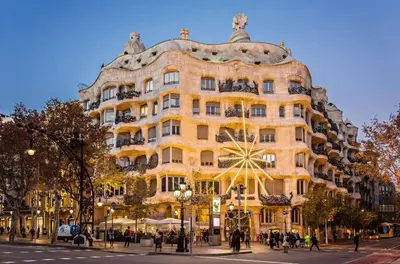 a large yellow building on a city street at Sweett - La Pedrera - Paseo de Gracia in Barcelona
