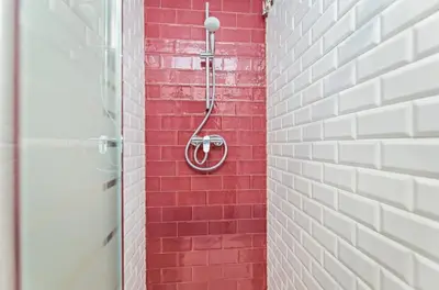 a shower in a red and white brick wall at Sweett - La Pedrera - Paseo de Gracia in Barcelona