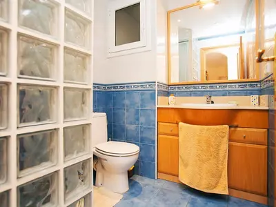 a bathroom with a toilet and a sink and a mirror at Apartment Mariola by Interhome in Sant Andreu de Llavaneres