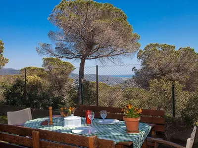a table with plates of food on it with a view at Holiday Home Ginesteres by Interhome in Argentona