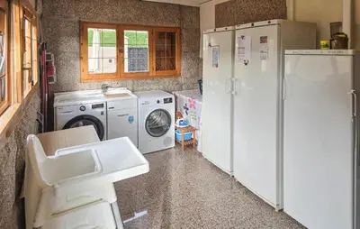 a kitchen with a refrigerator and a washer and dryer at Gorgeous Home In Alella in Alella