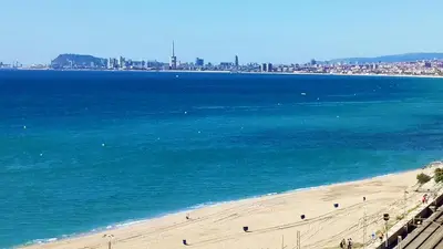a view of a beach with a city in the background at Marina Port & Beach-Apartment in Masnou