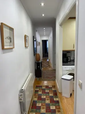 a hallway with a hallway leading to a kitchen at Channing Apartment in Barcelona