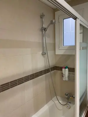 a bathroom with a shower and a tub at Channing Apartment in Barcelona