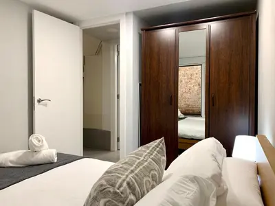 a bedroom with a bed and a mirror at Dalí Residence in Barcelona
