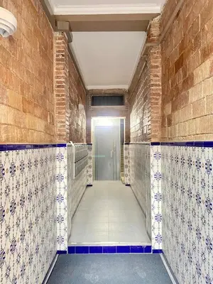 a corridor of a bathroom with tiles on the walls at Lovely loft near Barcelona center in Barcelona