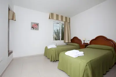 a room with two beds and a window at Sunway Torre La Veleta in Sitges