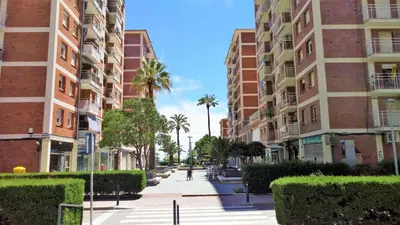 a city street with tall buildings and palm trees at Helena Seaview & Beach-apartment in Montgat