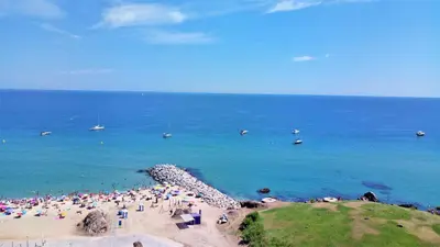 a crowd of people on a beach near the ocean at Claire Seaview & Beach-apartment in Montgat