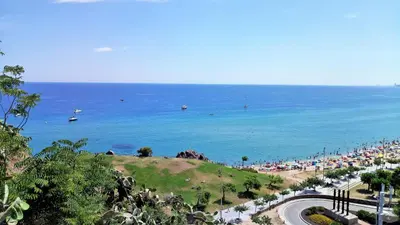 a beach with a crowd of people and the ocean at Claire Seaview & Beach-apartment in Montgat