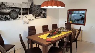 a dining room with a wooden table and chairs at Claire Seaview & Beach-apartment in Montgat