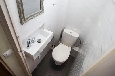 a white bathroom with a toilet and a sink at Mai & Maud Paralel Apartment in Barcelona