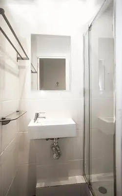 a white bathroom with a sink and a shower at Mai & Maud Paralel Apartment in Barcelona