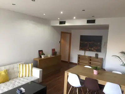 a living room with a couch and a table at Apartamento FIRA Barcelona in Hospitalet de Llobregat