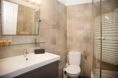 a bathroom with a sink and a toilet and a shower at Mai & Maud Ronda Apartment in Barcelona