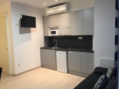 a small kitchen with a sink and a microwave at Apartahotel Baldiri in Sant Boi del Llobregat
