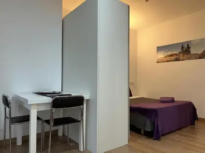 a room with a white table and a bed at Apartahotel Baldiri in Sant Boi del Llobregat